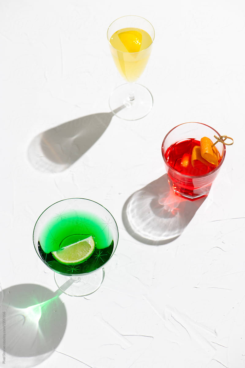 Various colorful alcohol cocktails on white