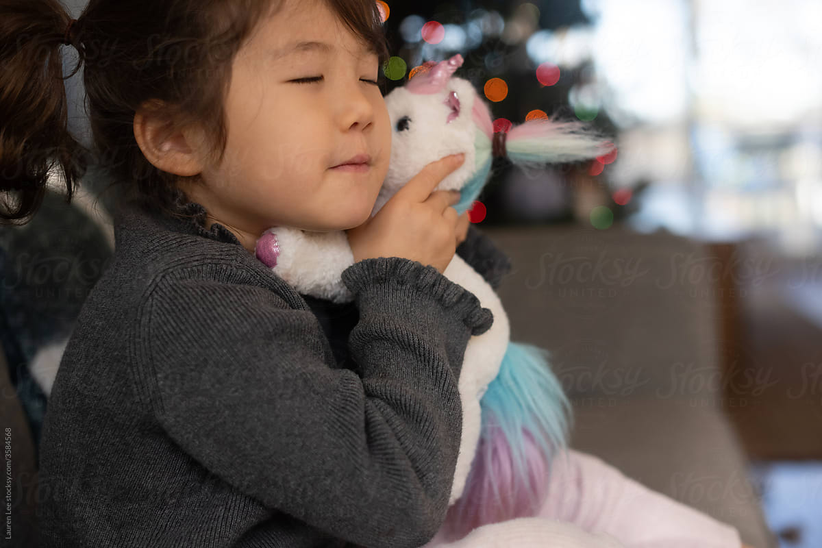 Blissful child hugging stuffed animal