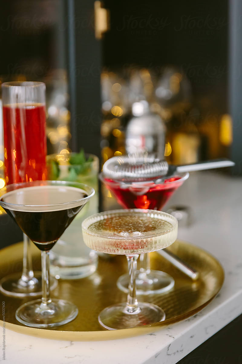 A selection of cocktails on a brass tray
