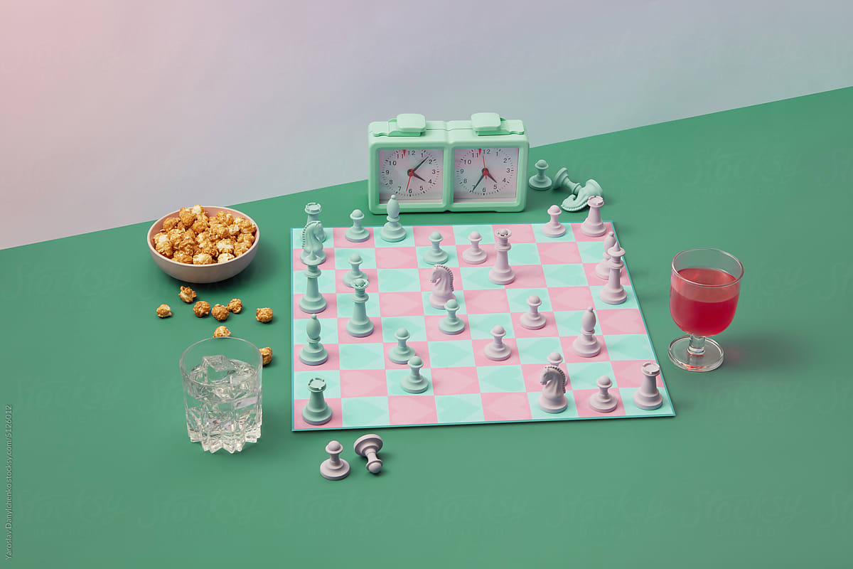 Chess board with heart pattern and party snacks.