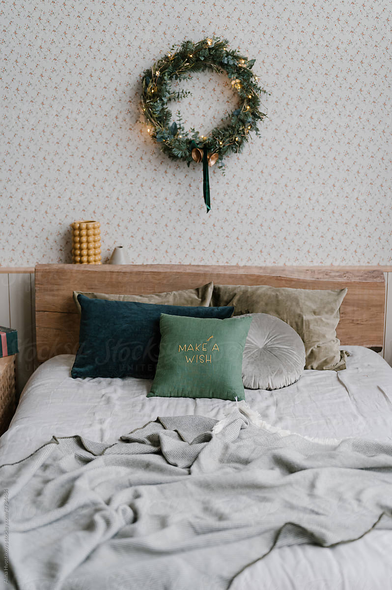 Christmas wreath over unmade bed