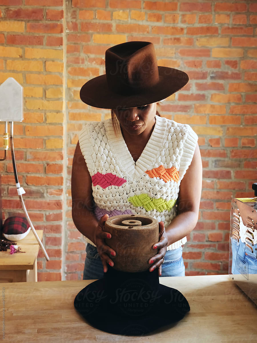 Black Woman Hat Maker In A Workshop Space, Sews On A Sewing