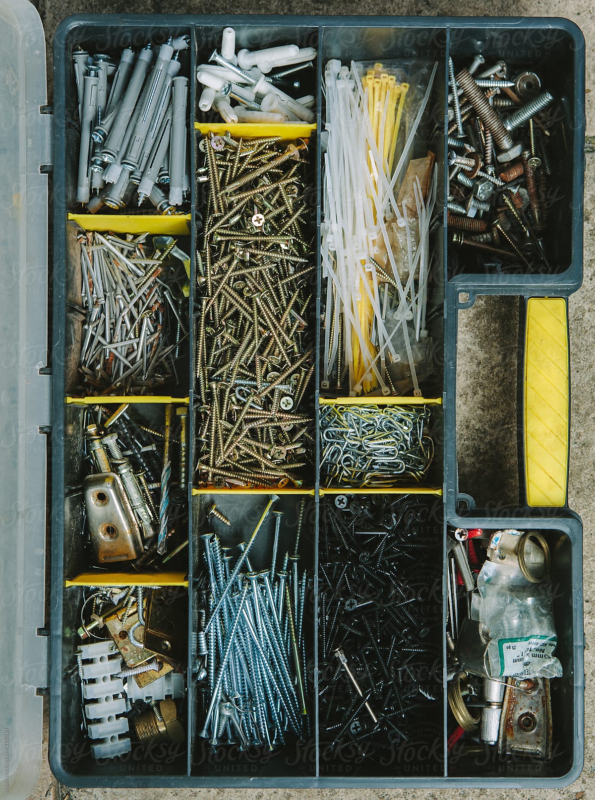 Toolbox containing various screws bolts and drill bits.