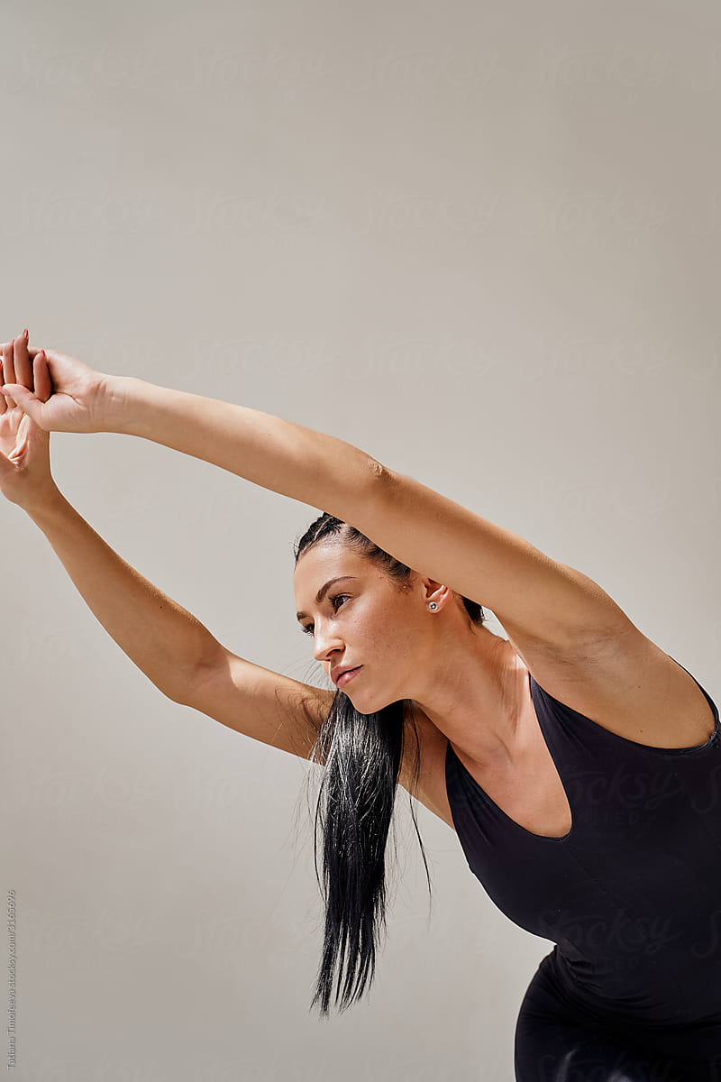 The Woman Stretches Her Arms Out In Front Of Her by Stocksy Contributor  Tatiana Timofeeva - Stocksy