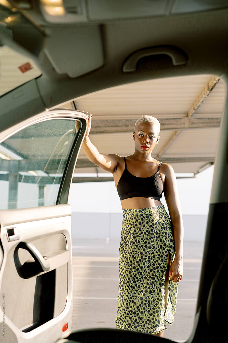 Black woman opening car door
