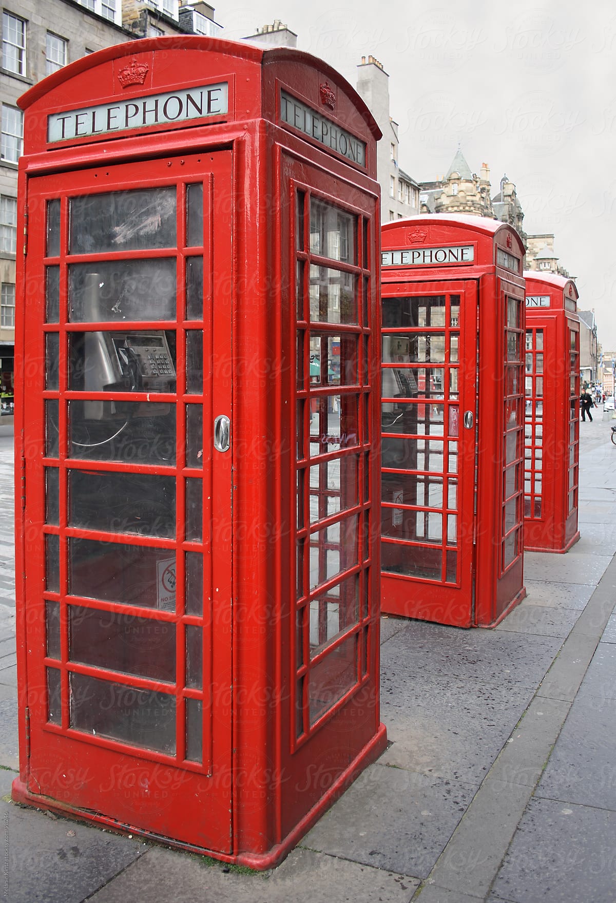 Three typical English phone boxes in a row