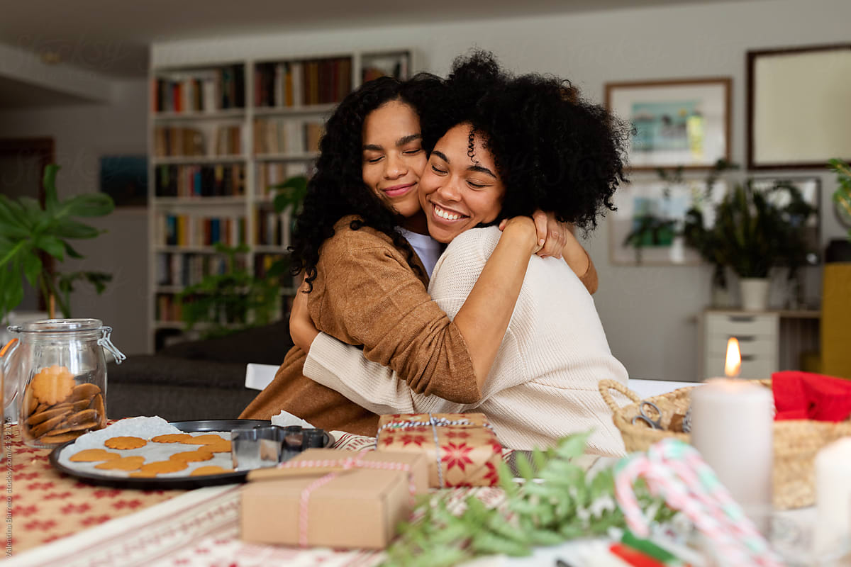 Women hugging in Christmas at home