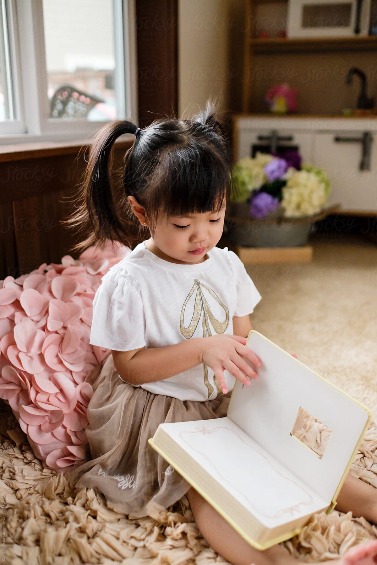 Asian Toddler Girl Reading A Book At Home by Stocksy Contributor Take A  Pix Media - Stocksy