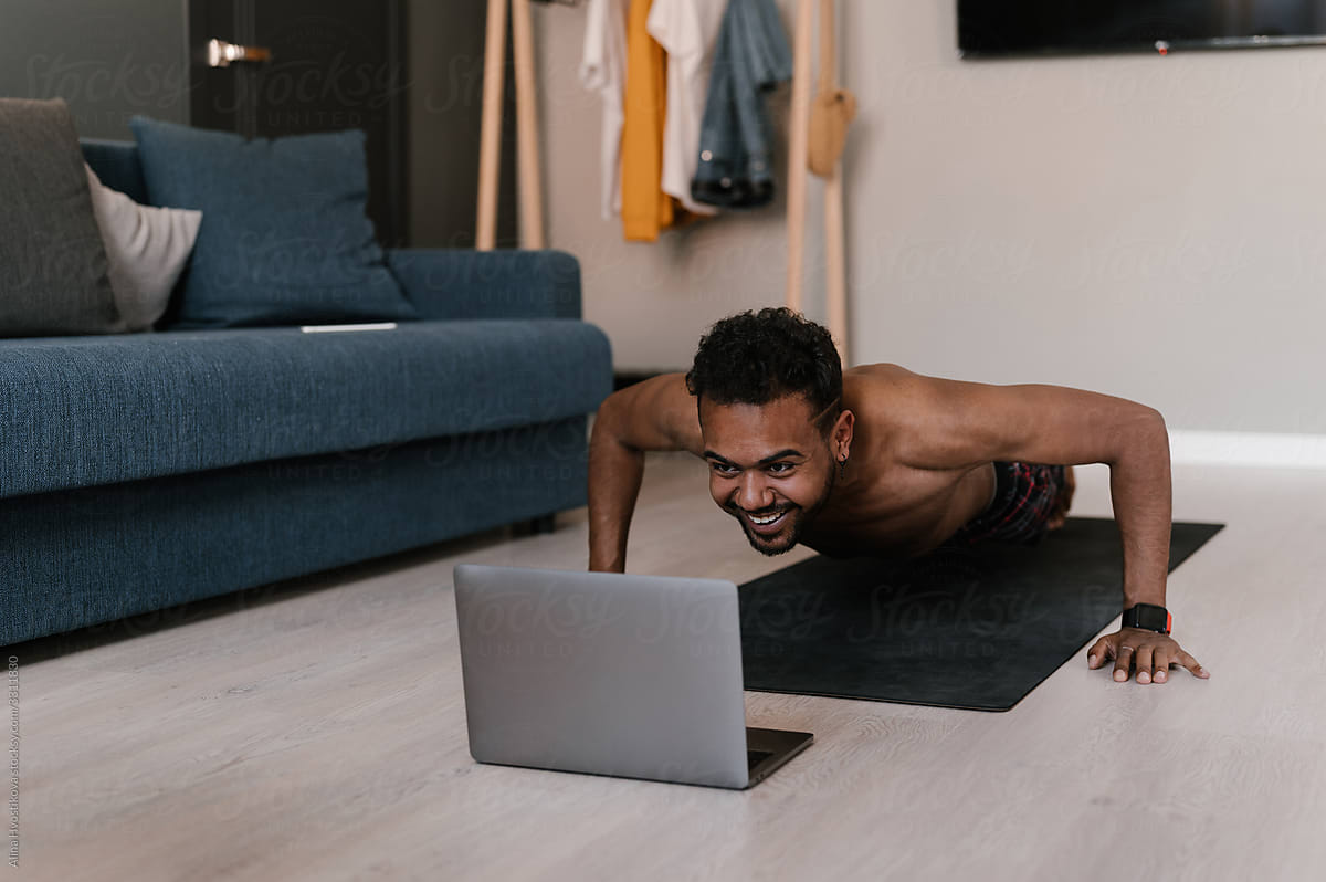 Happy black athlete during online workout at home
