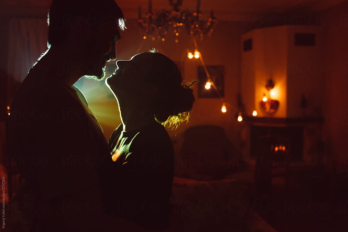 Passionate couple in the beam of projector