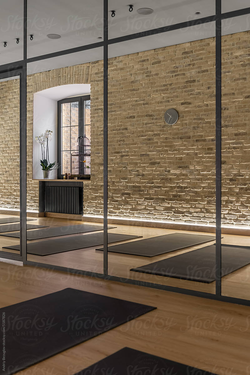 Modern interior of yoga studio with mirrored wall