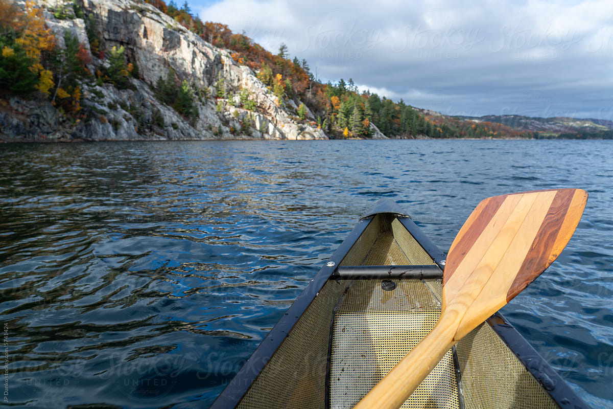 Canoe with Wood Paddle on Autumn Wilderness Lake