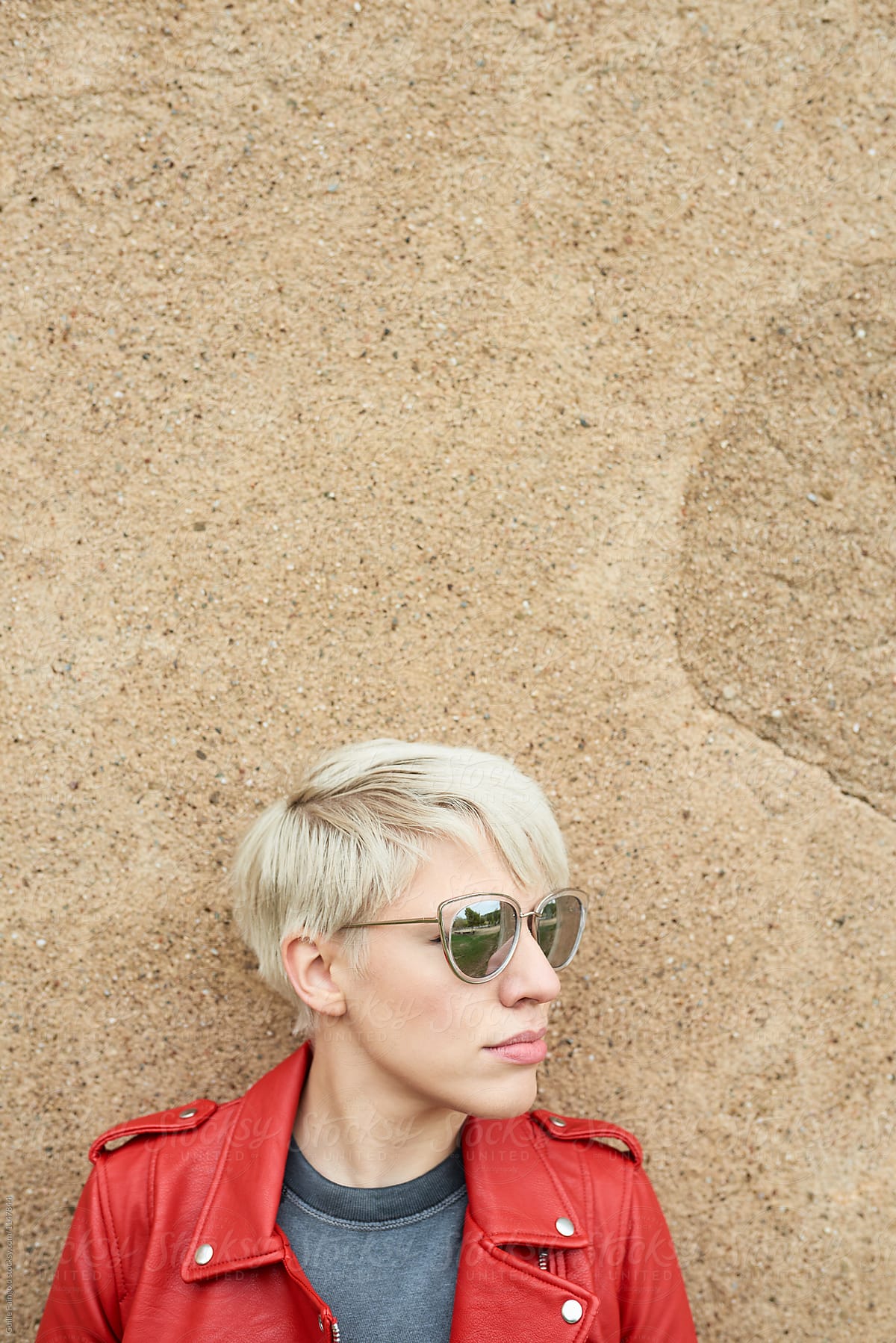 blonde in red leather jacket and sunglasses