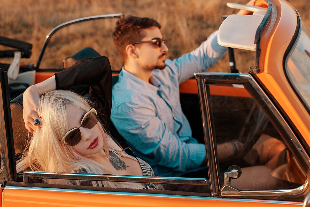 Couple in a convertible car on a road trip