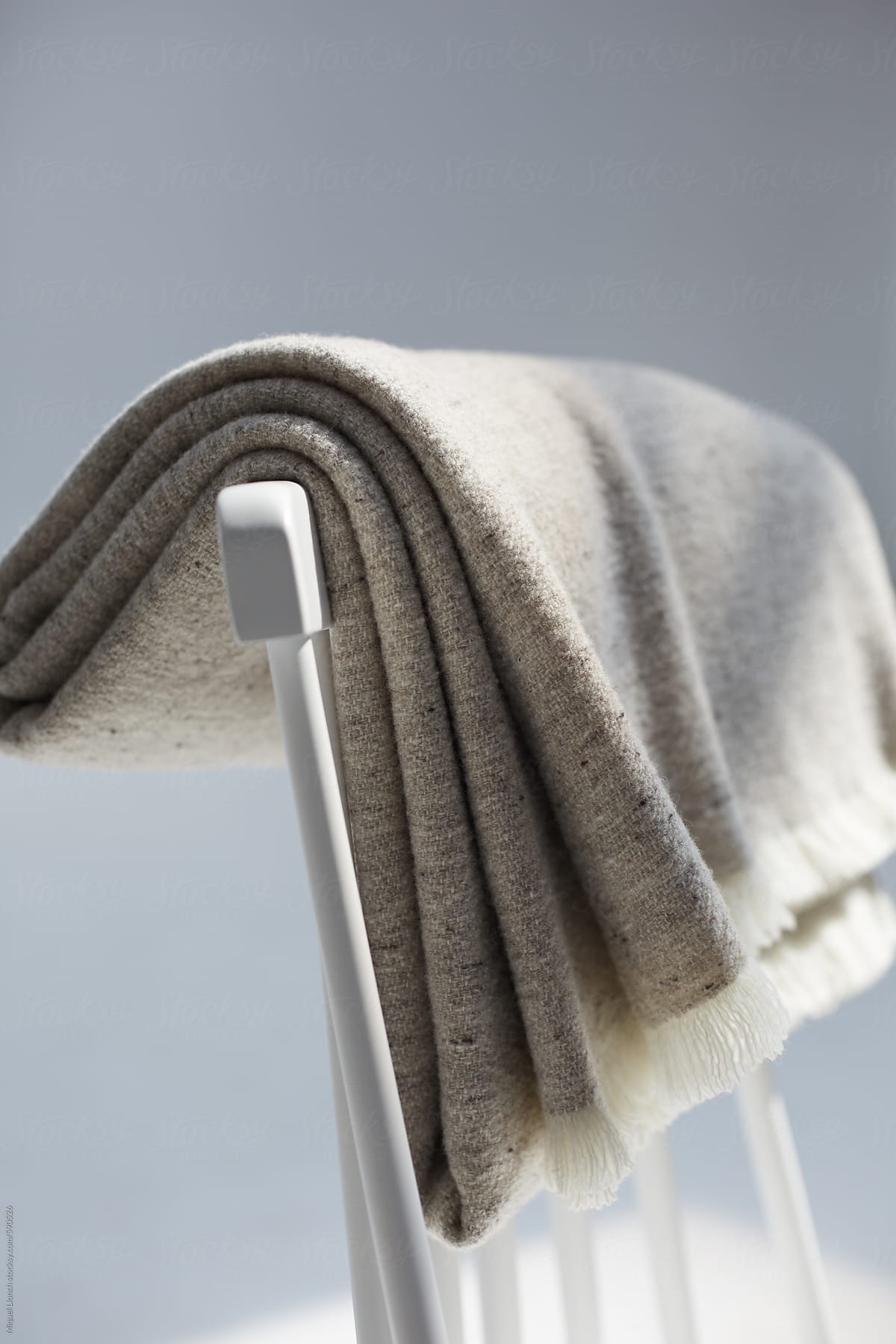 Handmade wool blanket on a white chair