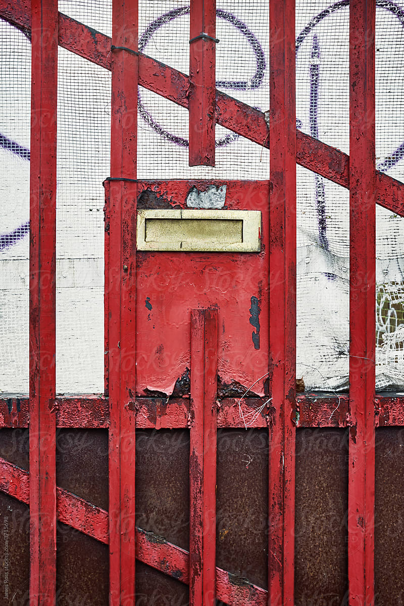 Letterbox surrounded by a metal grill