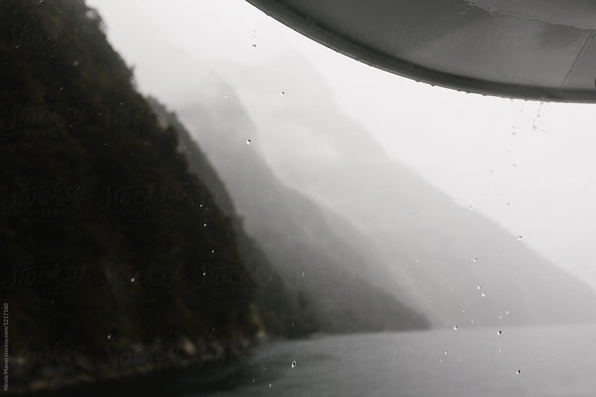 rain drops falling from edge of ferry in milford sound