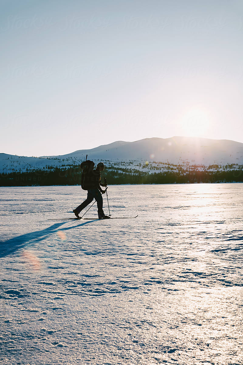 Male Solo Skier on Frozen Lake
