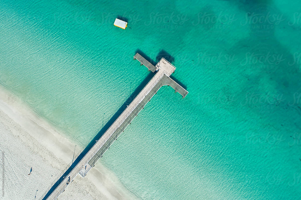 Aerial image of pier, dock on coastline in summer