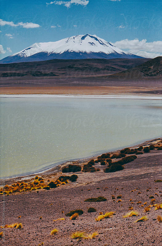 Snow-Covered Andean Peak With Turquoise Lake Shot on Film