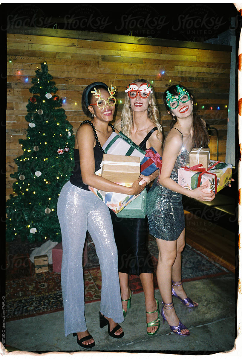 User generated content cool women with present boxes during Christmas