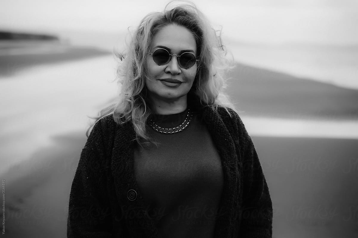 Black And White Outdoor Portrait Of A Senior Woman wearing round sunglasses