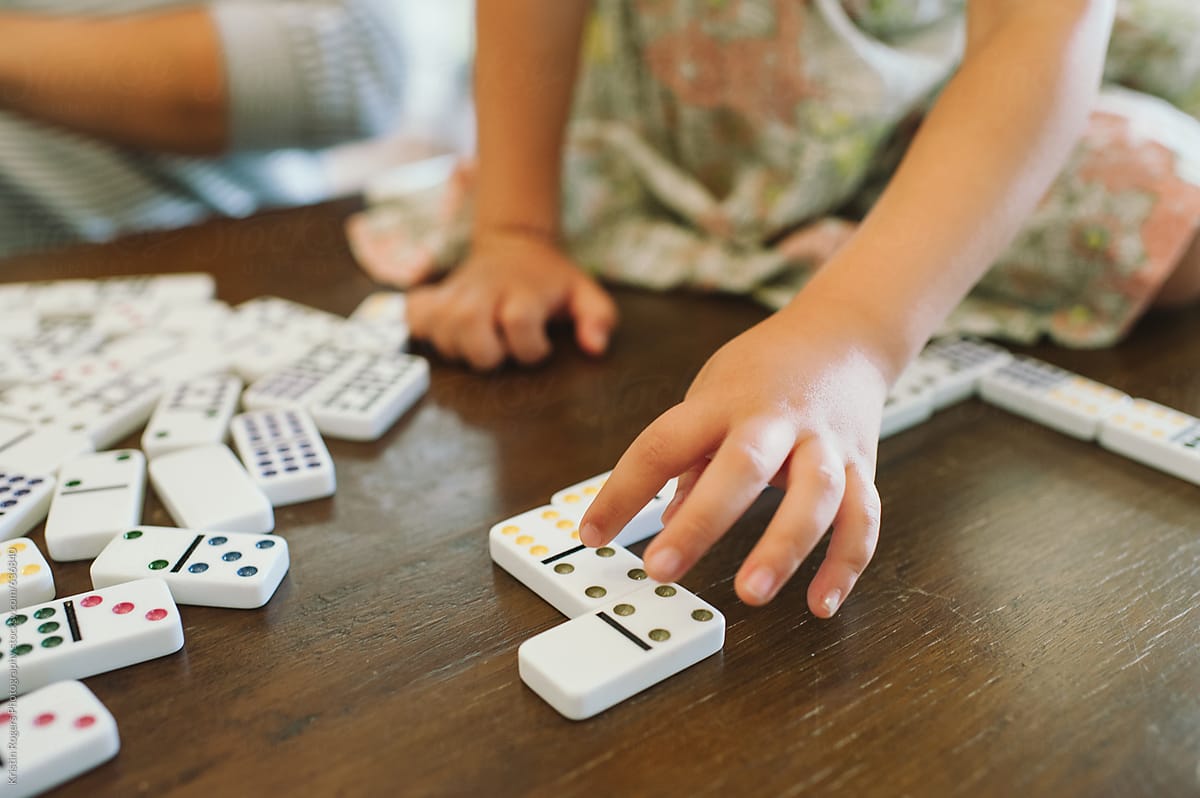 Child working with domino\'s for homeschool math lesson