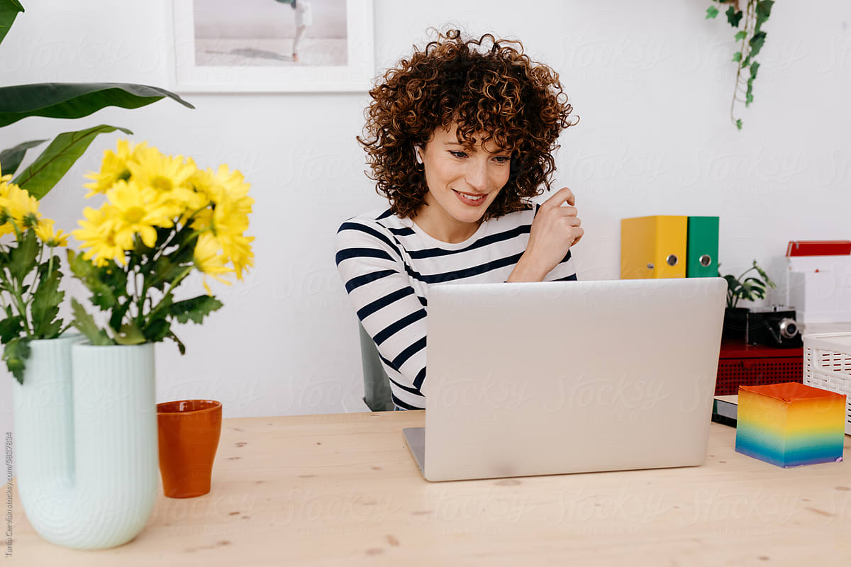 Happy woman working with laptop in workplace