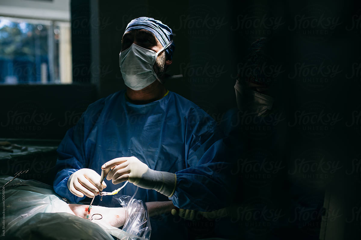 Male veterinary making injection during surgery