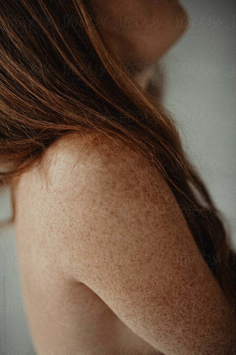 Close Up woman's skin texture of Ginger female with many freckles