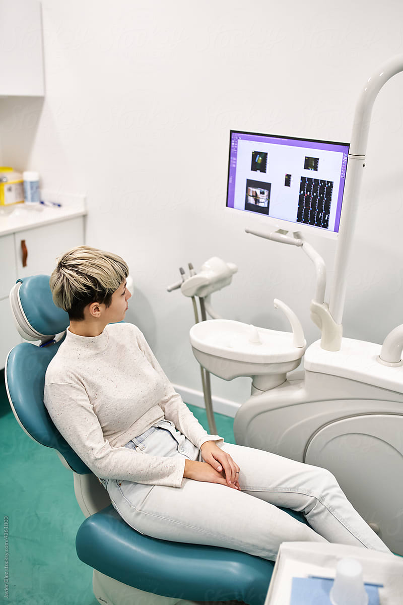 Black dentist examining teeth scans