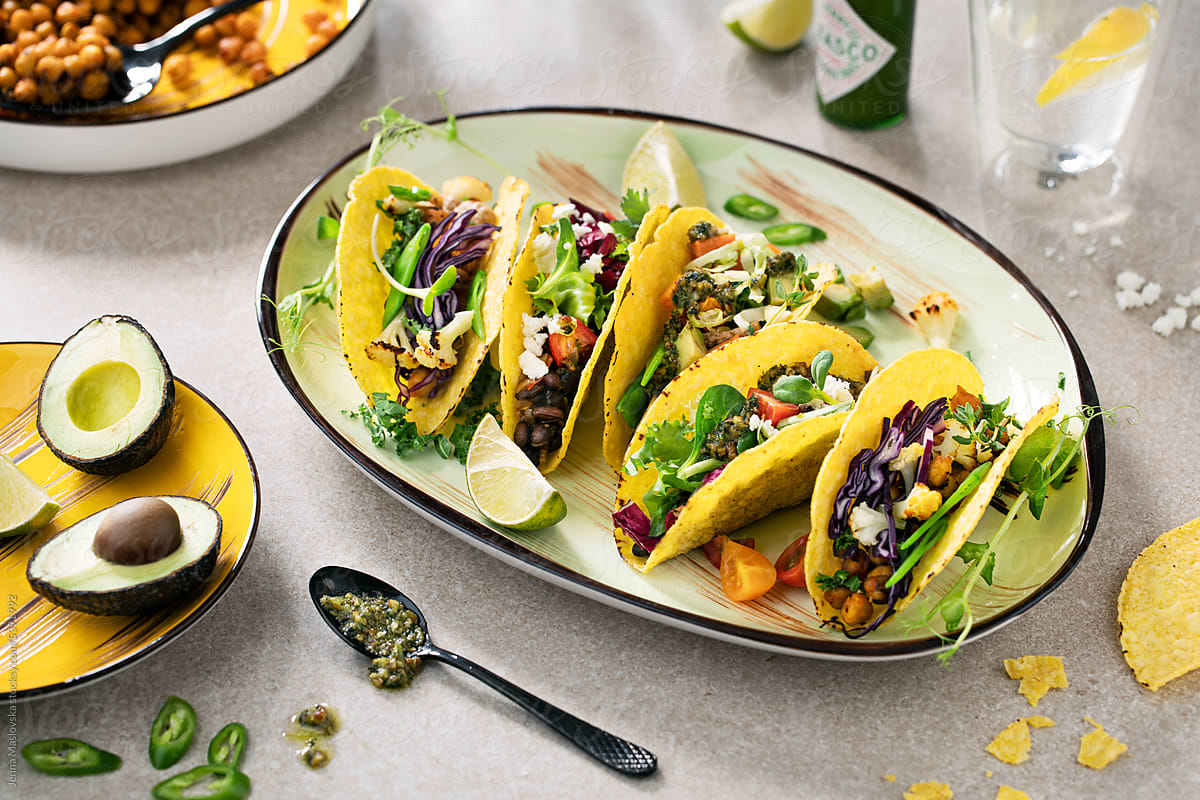 Overhead healthy vegetarian tacos on a plate with ingredients