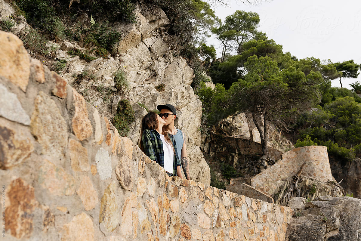 Young couple kissing against cliff