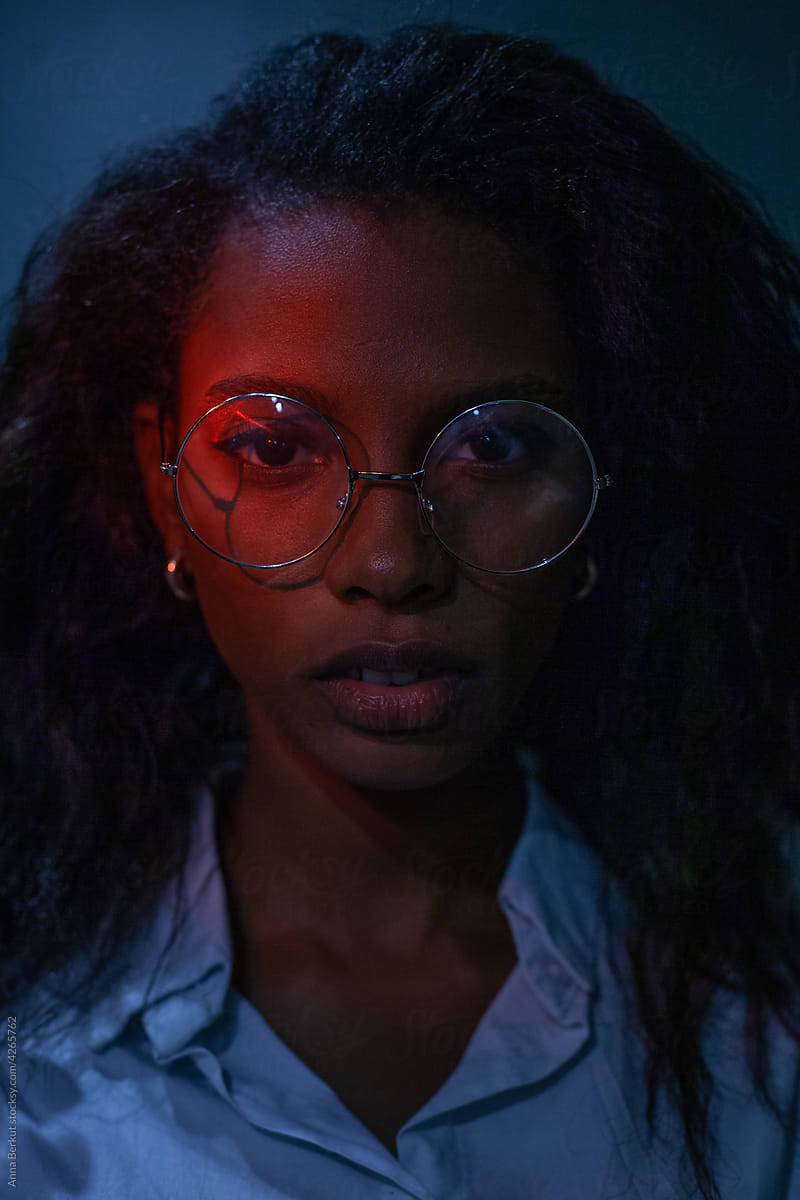 serious young woman wearing glasses looking at camera