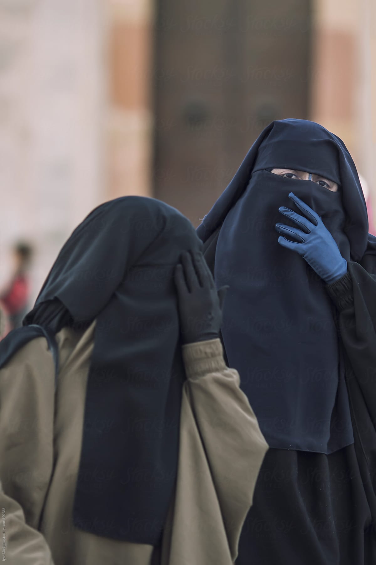 two traditional Muslim women in Medina,North Africa  hiding their faces from the camera