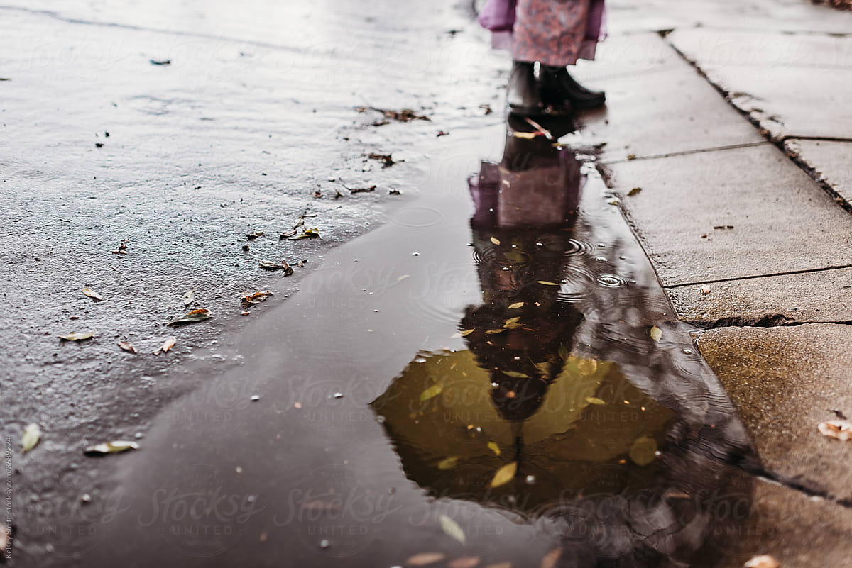 Reflection of girl in puddle