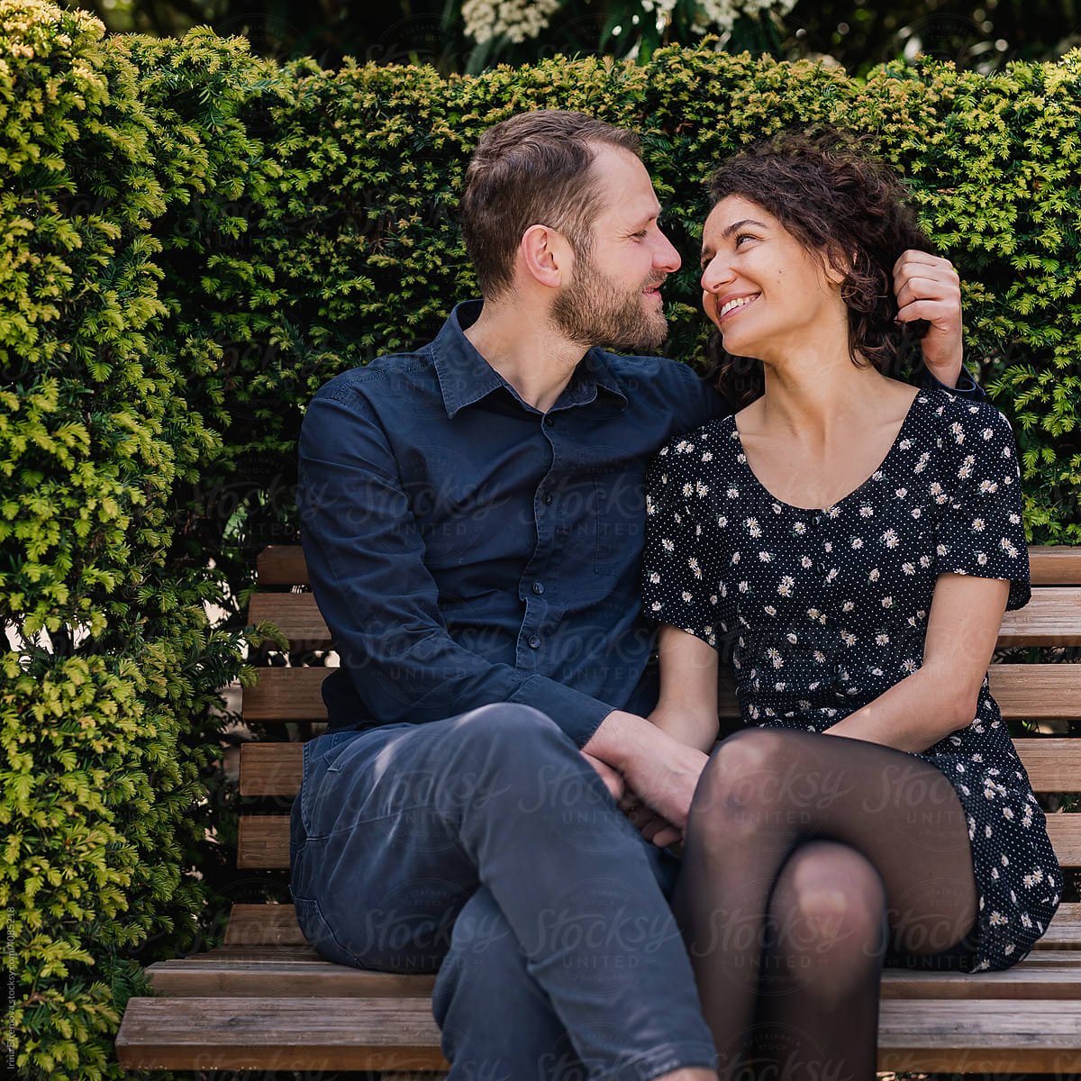 Romantic couple talking on park bench