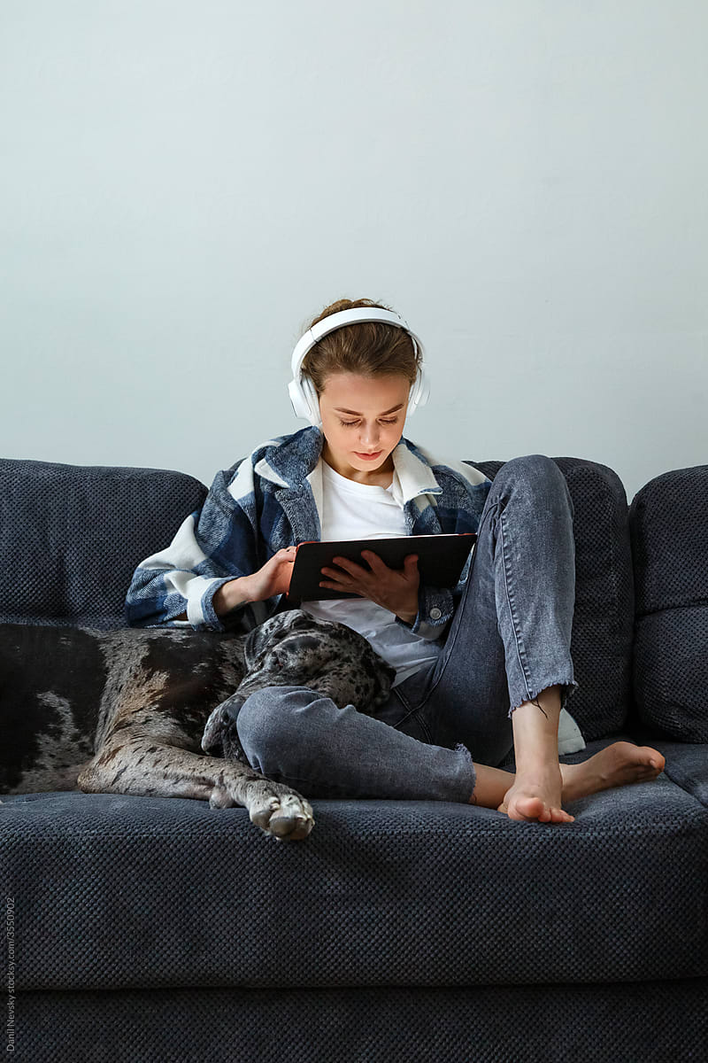 Young woman using tablet near dog