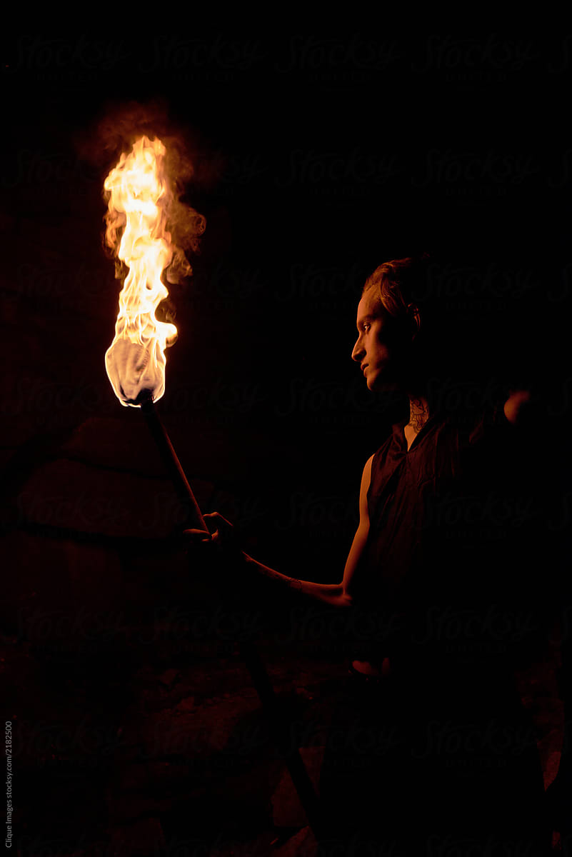 Man With Torch In The Dark Stocksy United