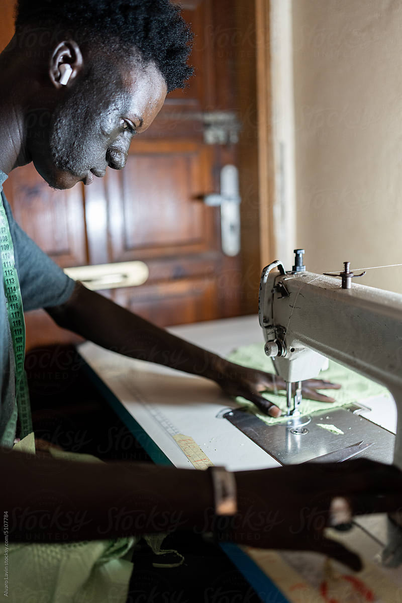 male dressmaker using sewing machine