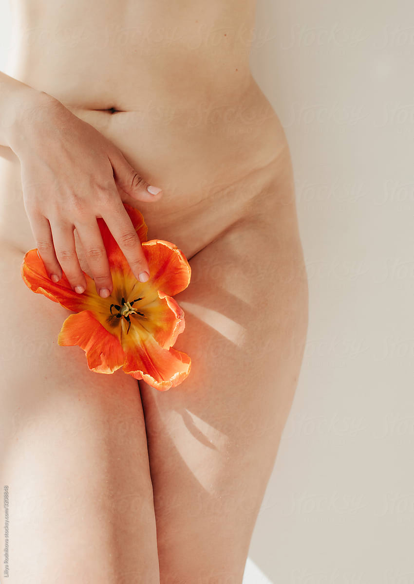 woman with flower in genital area