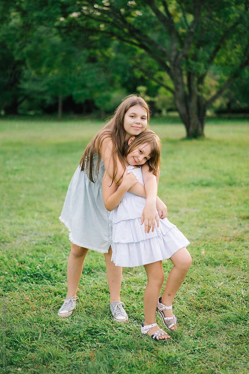 Cute Girls Hugging In Summer Park By Stocksy Contributor Dreamwood Photography Stocksy 