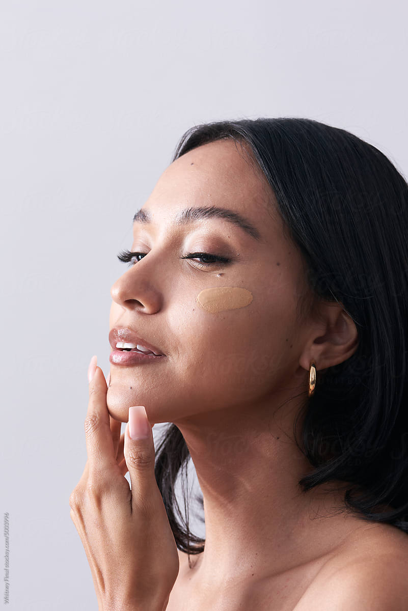 Young Woman with Makeup Cosmetics Foundation Swatch on Face