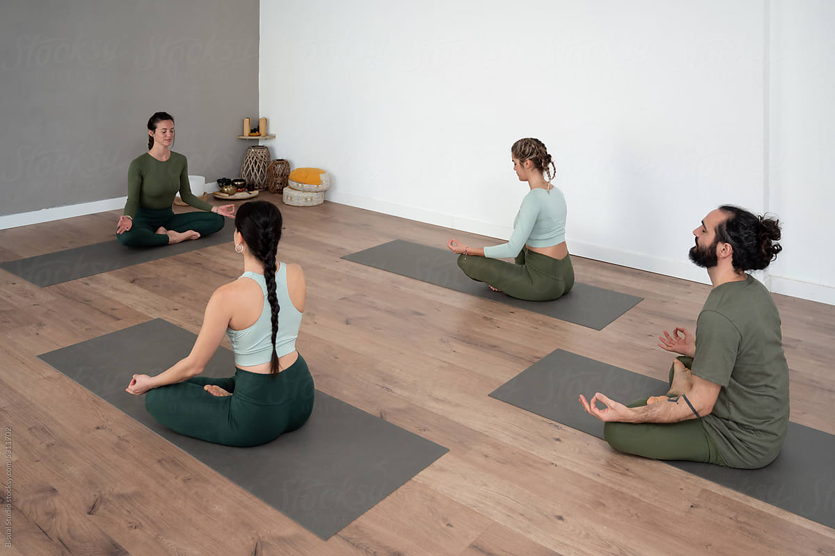 Group of people meditating in yoga studio