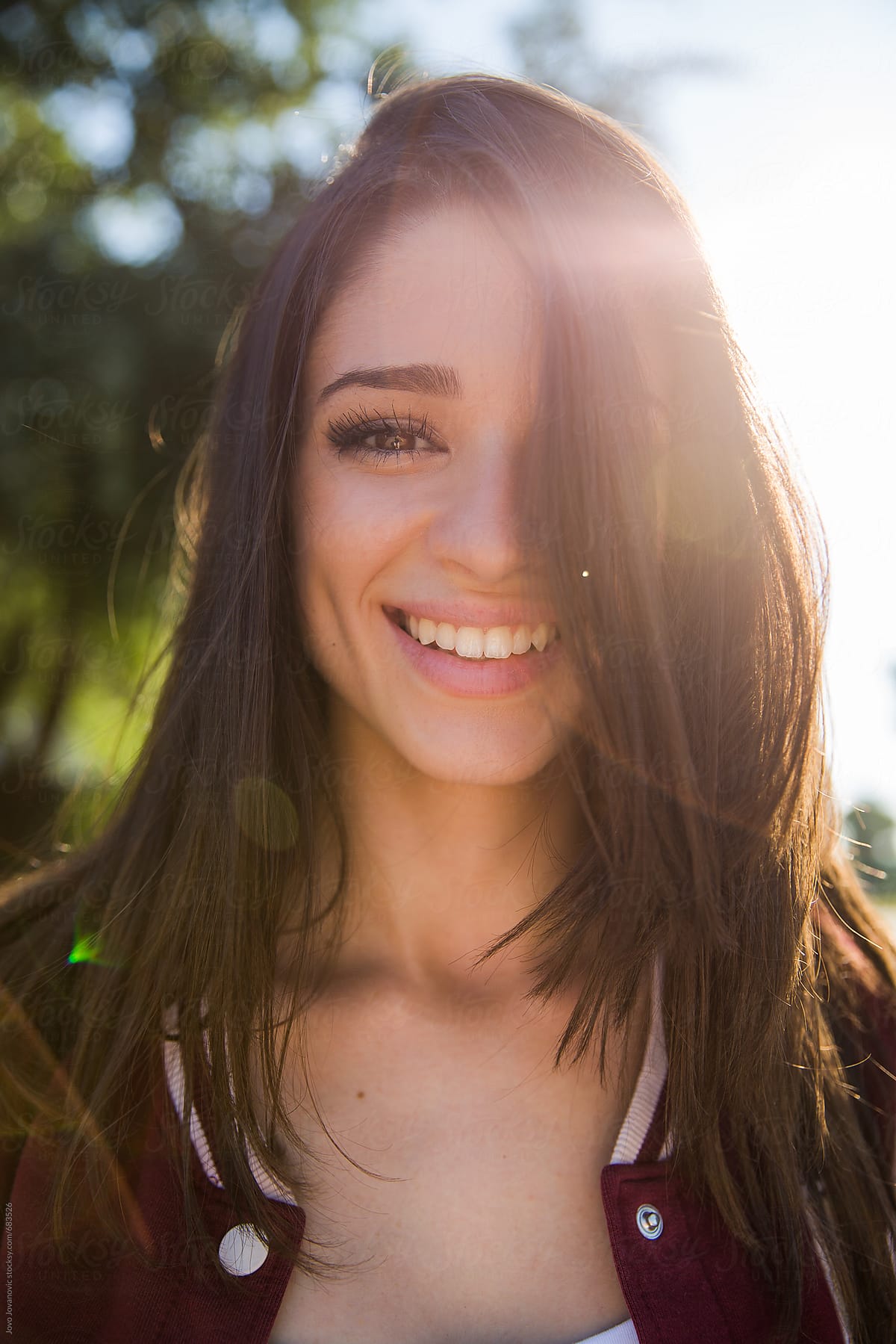 Portrait of a beautiful brunette smiling and looking at the camera