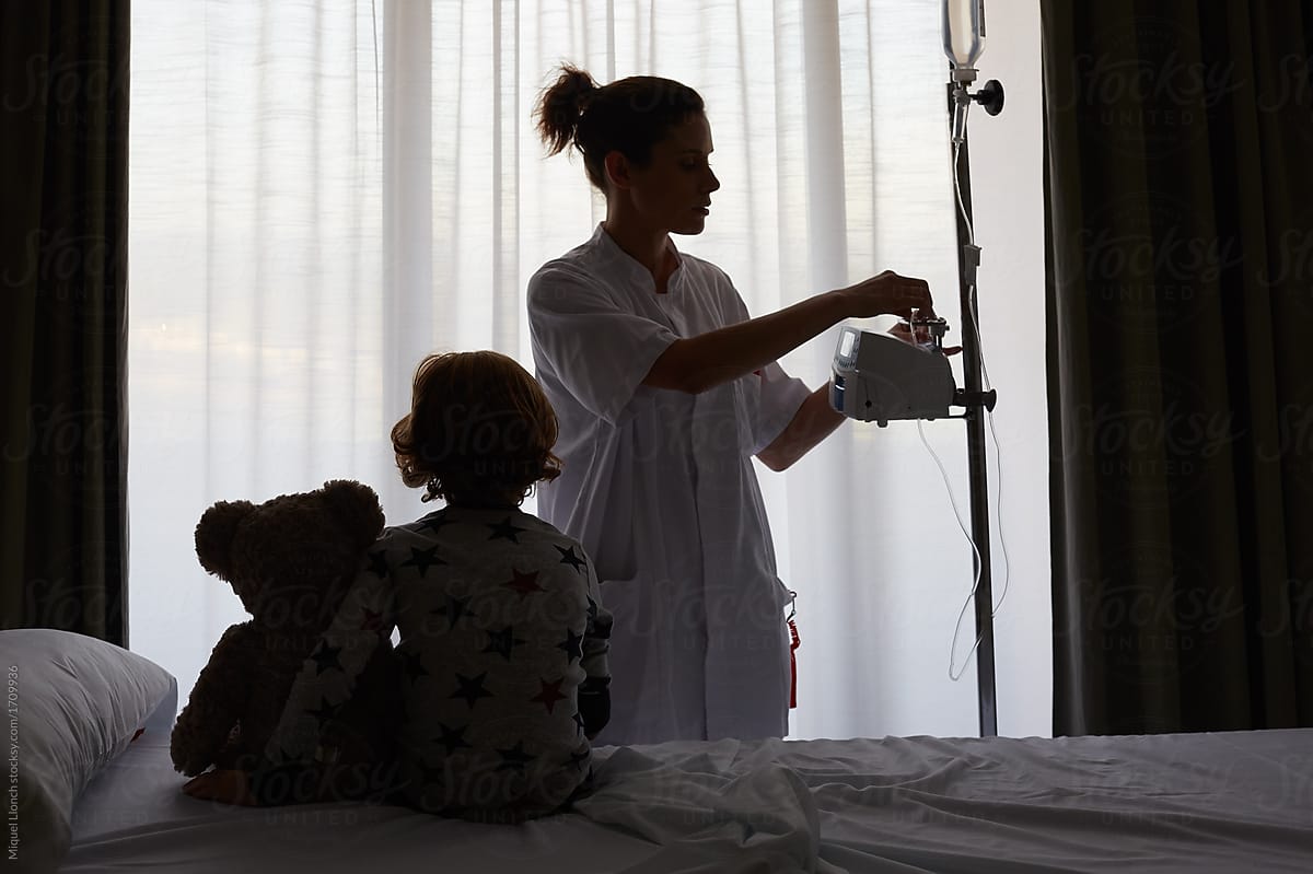 Patient child and nurse in hospital room