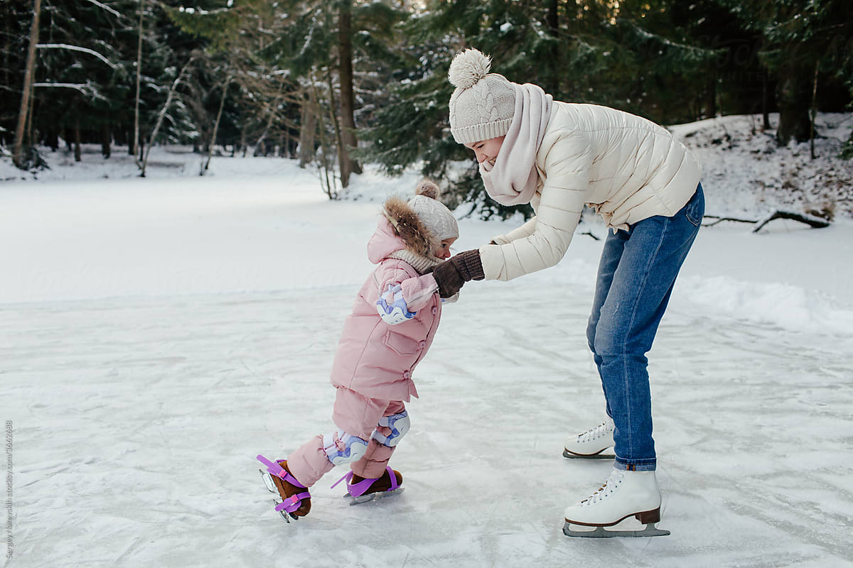 Mother helping child to skate