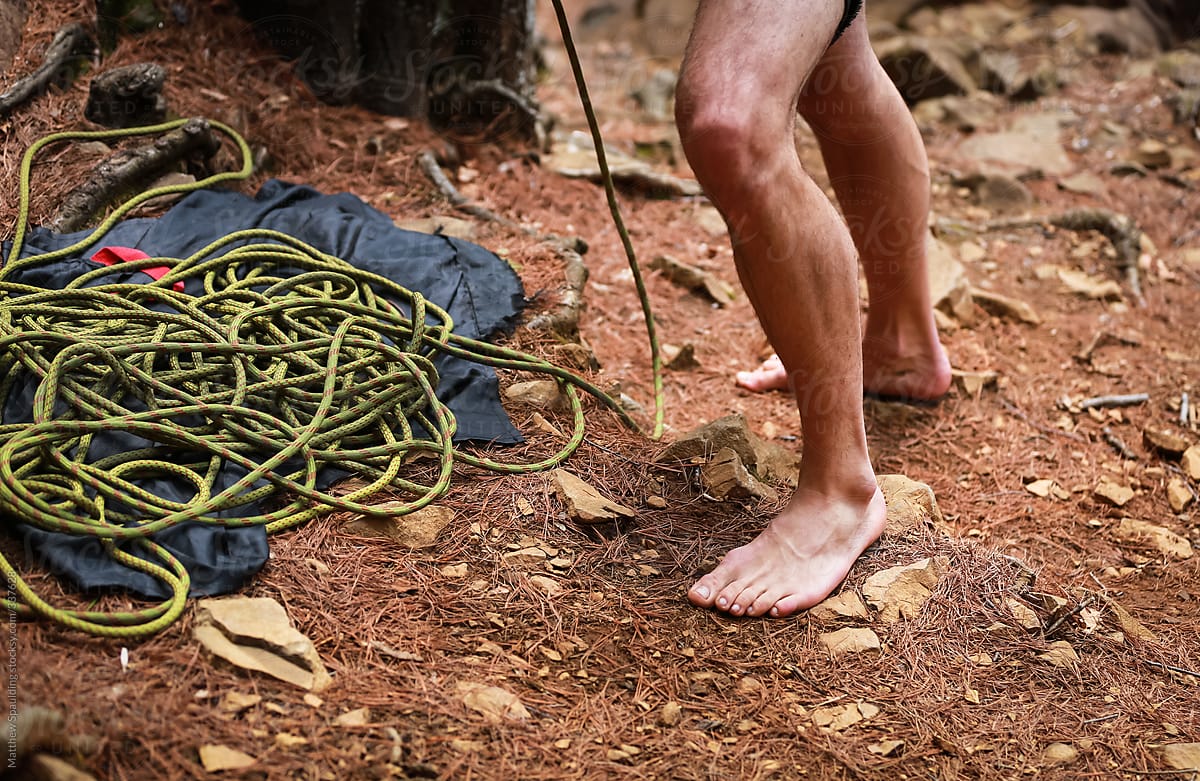 Legs Of Barefoot Man Standing In Dirt With Rock Climbing Rope by Stocksy  Contributor Matthew Spaulding - Stocksy