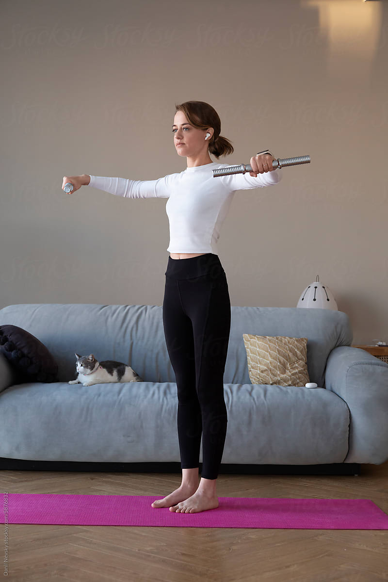 Young woman doing exercise on mat at home