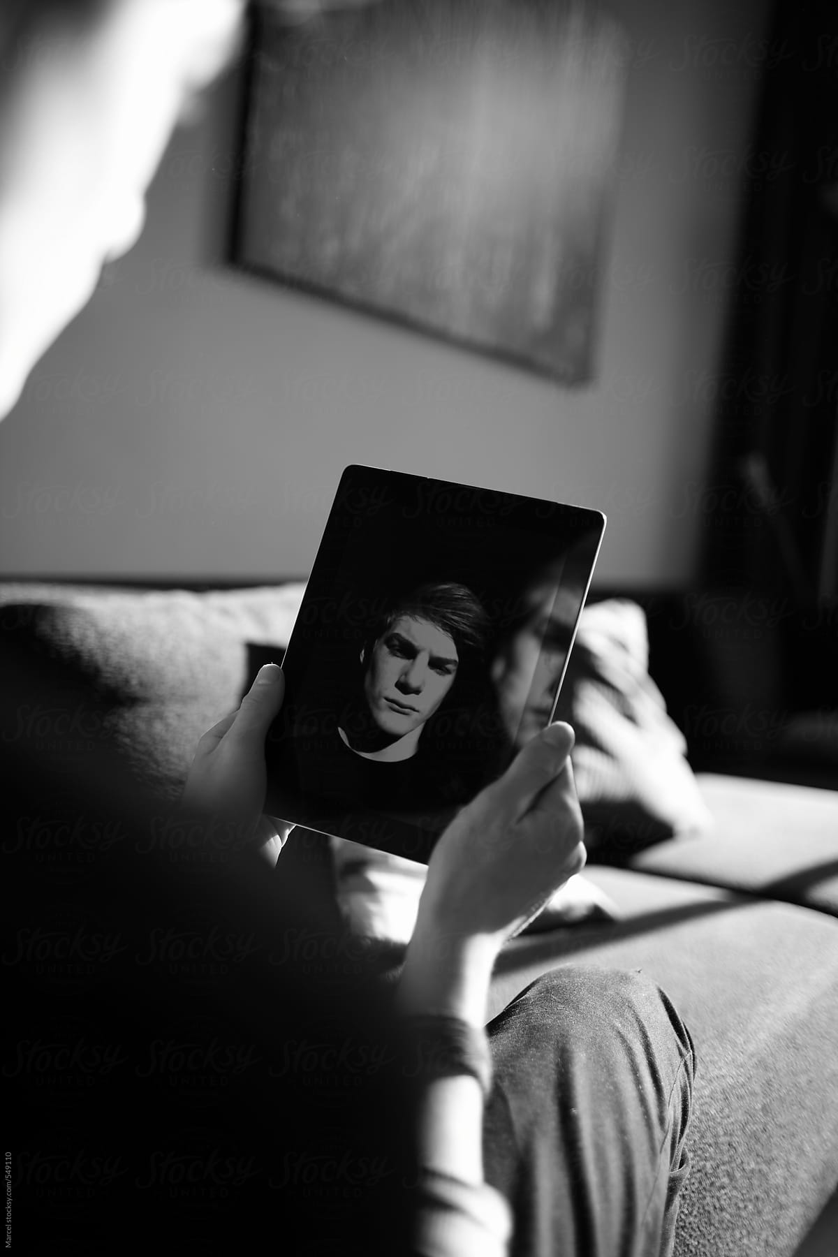 teenage boy taking a selfie on a tablet device